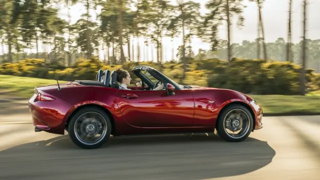 The side exterior of a red Mazda MX-5