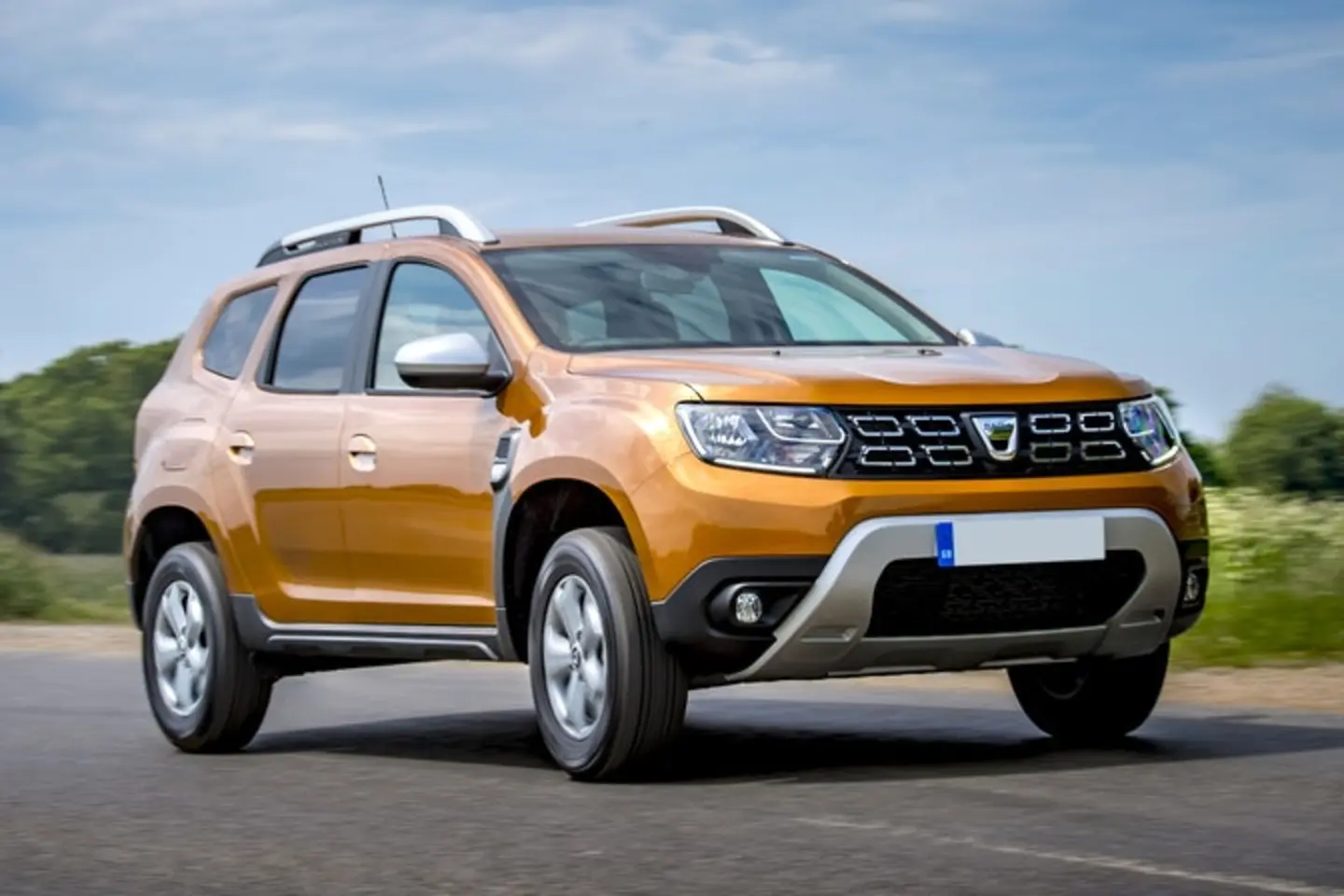 The front exterior of a gold Dacia Duster