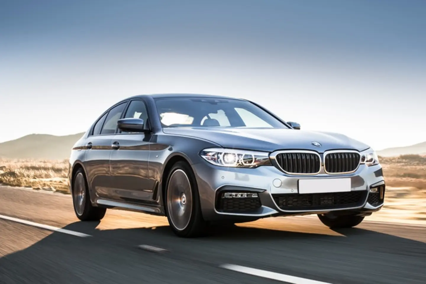 The front exterior of a silver BMW 5-Series