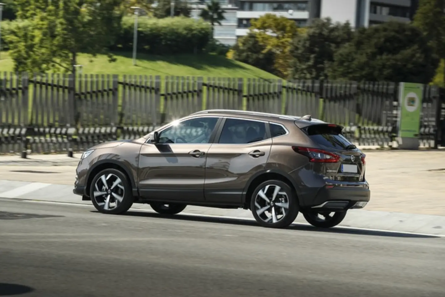 The side exterior of a brown Nissan Qashqai