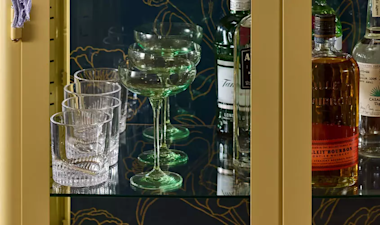 Glassware cabinet home bar whiskey glasses and coupes with bottles