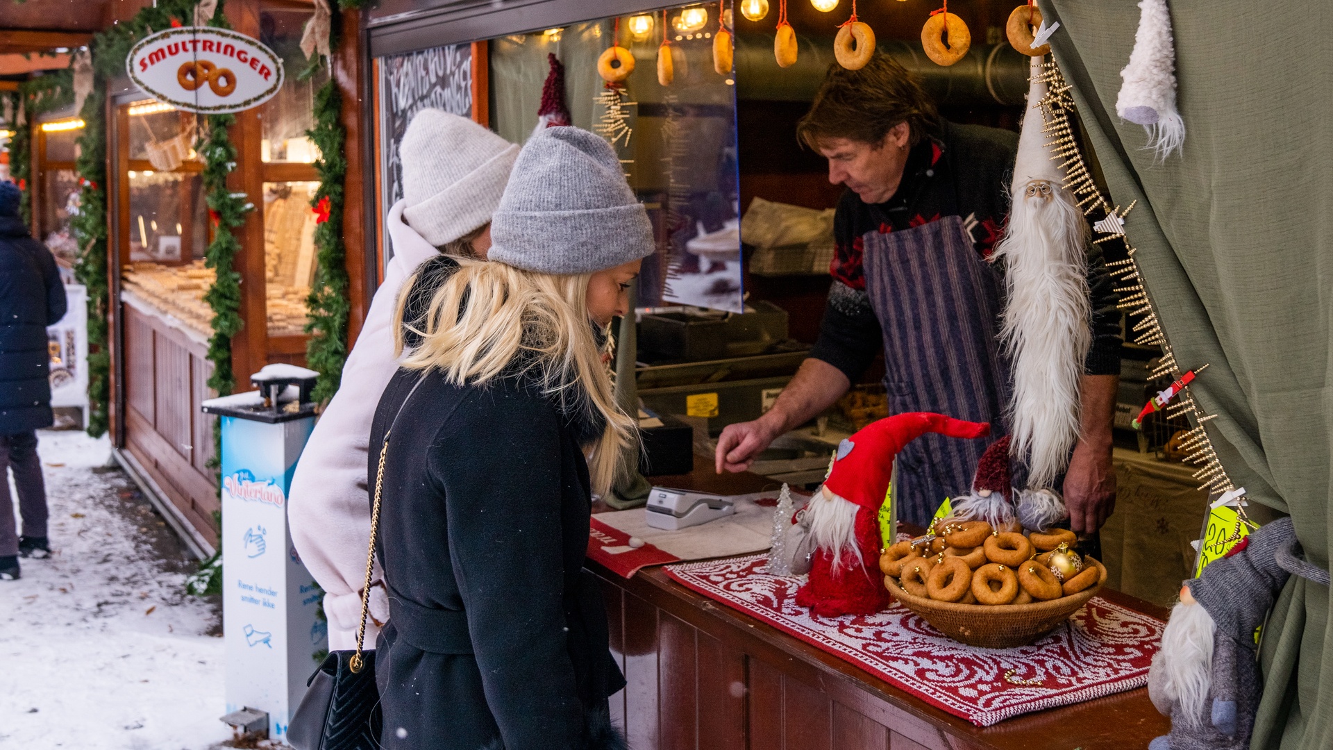Norway Christmas market - tasting food at local food stand Fredrik Ahlsen - Maverix Media AS