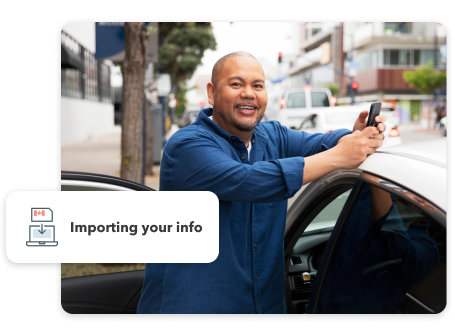 A man is holding his smartphone and smiling while leaning on his car, which is parked on the street. Secondary illustration reads “Importing your info”.