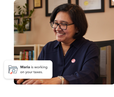 TurboTax expert, Maria on her laptop and the text “Maria is working on your taxes”.