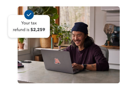 A young man smiling while working on his laptop in his home setting. Secondary illustration with “Your tax refund is $2,259” text and checkmark.