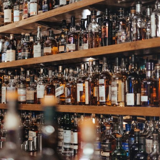  Multiple shelves filled with whisky bottles 