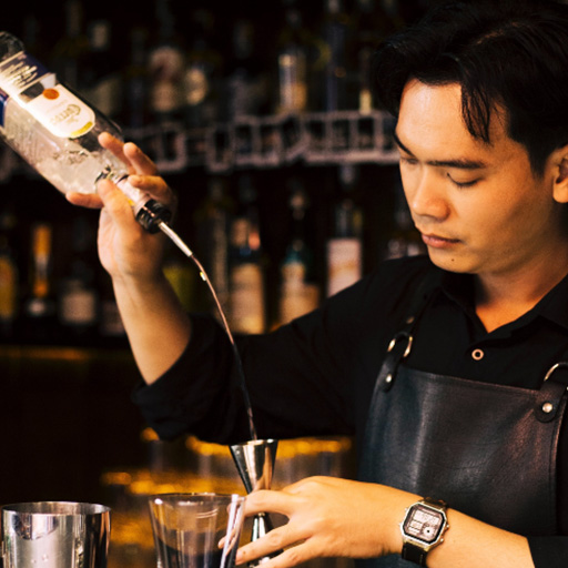 Bartender pouring liquid using speed pourer