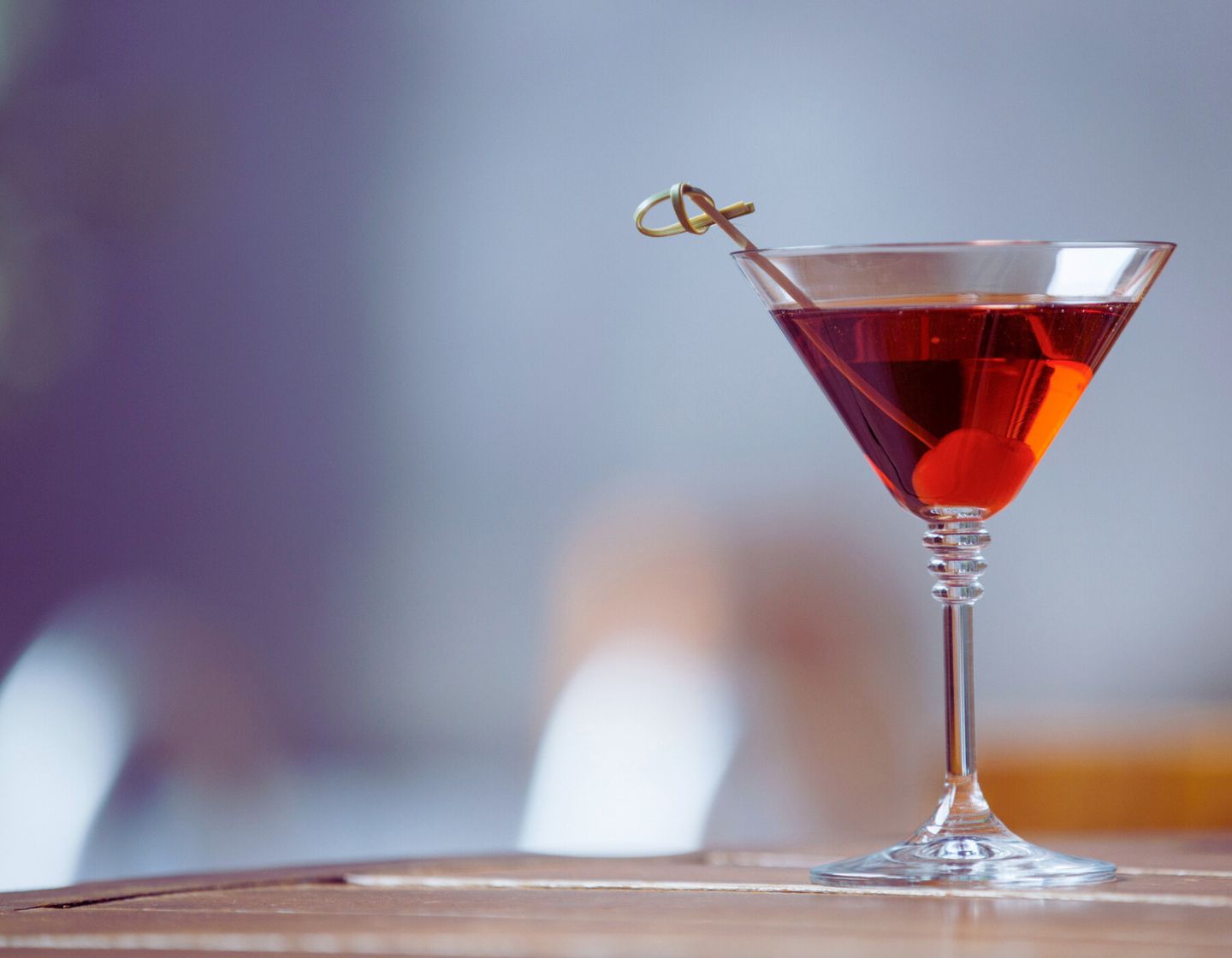 Red cocktail in a cocktail glas and garnish.