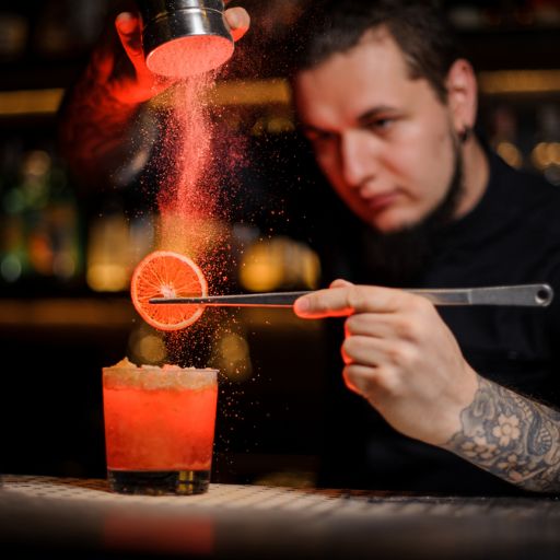 Bartender prepping the garnish on the cocktail