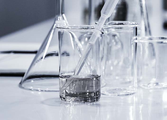 Glass lab equipment on a white counter