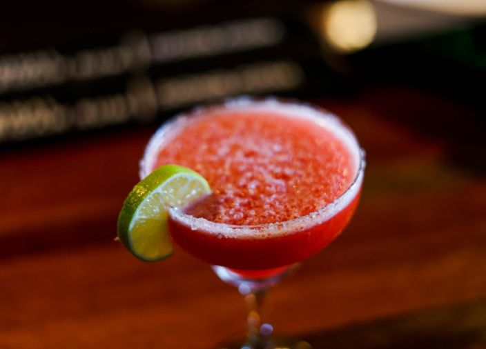 Frozen red margarita with salty rim and lime slice