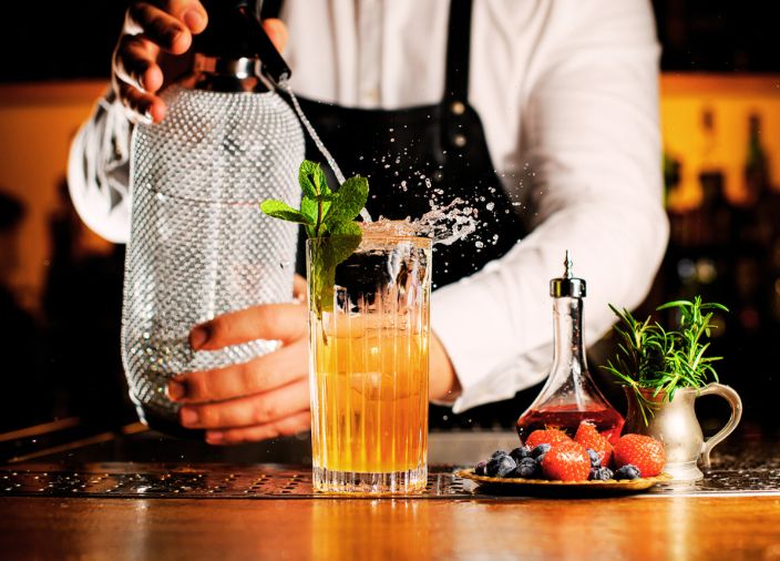 Carbonated cocktail being filled by a bartender.