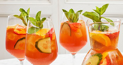Cocktails in wine glasses with mint garnish 