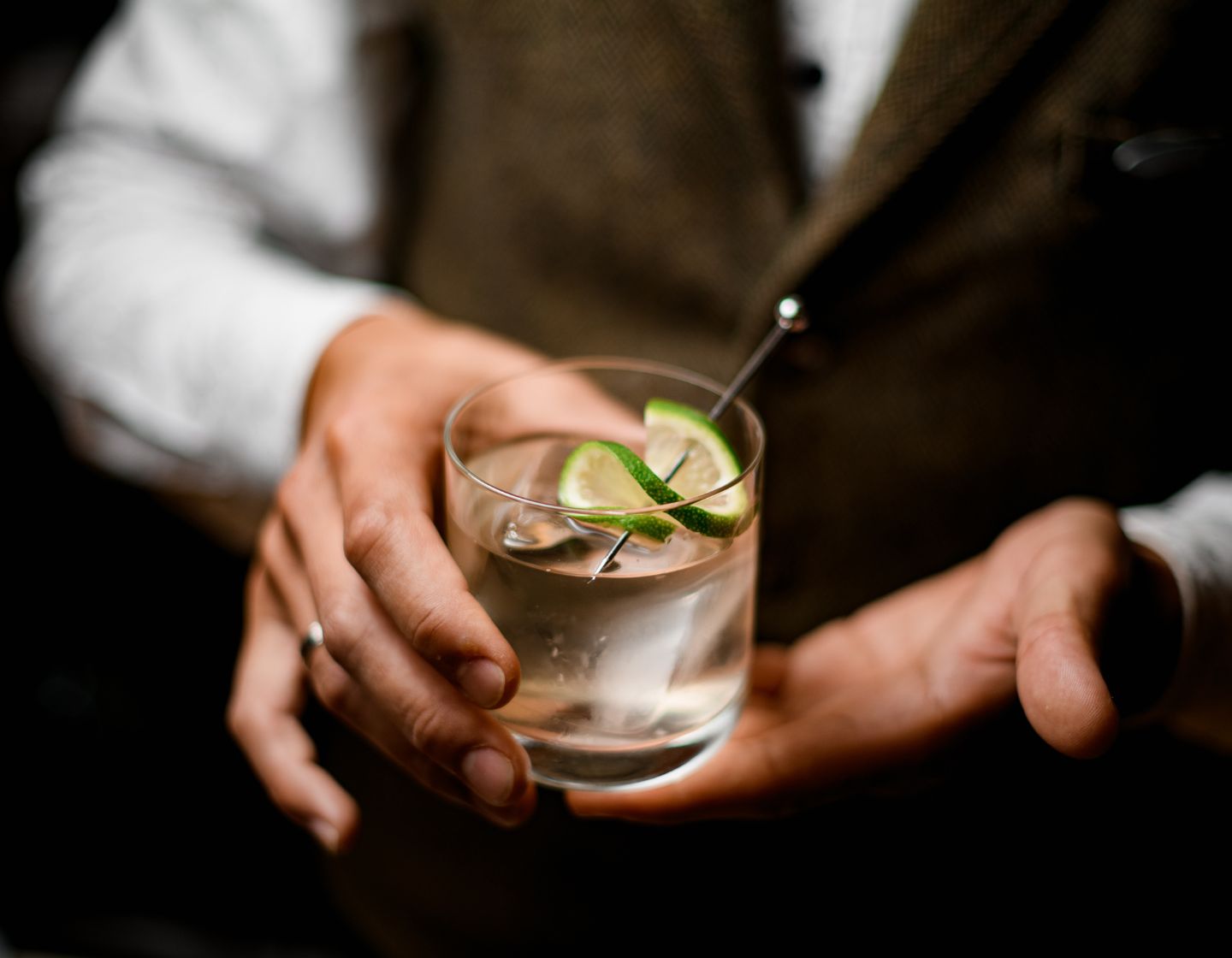 two hands holding a drink