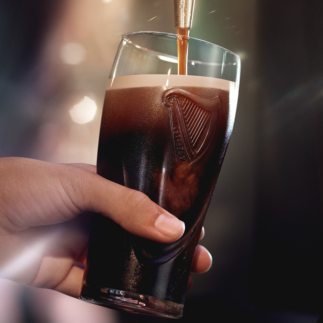 Pint of Guinness being poured from tap