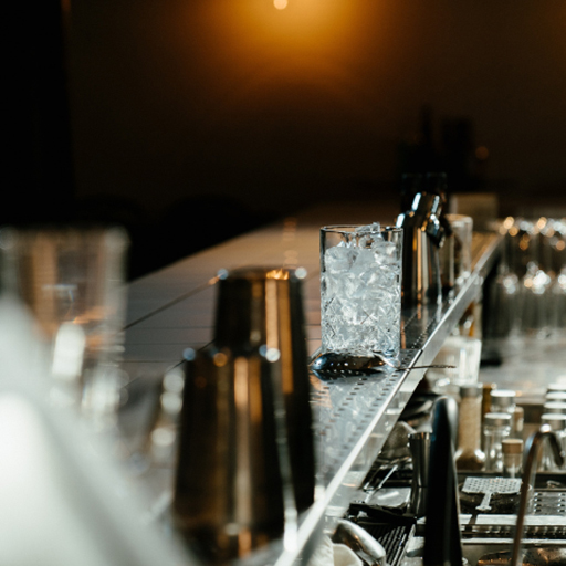 Bar set-up with empty glass with ice