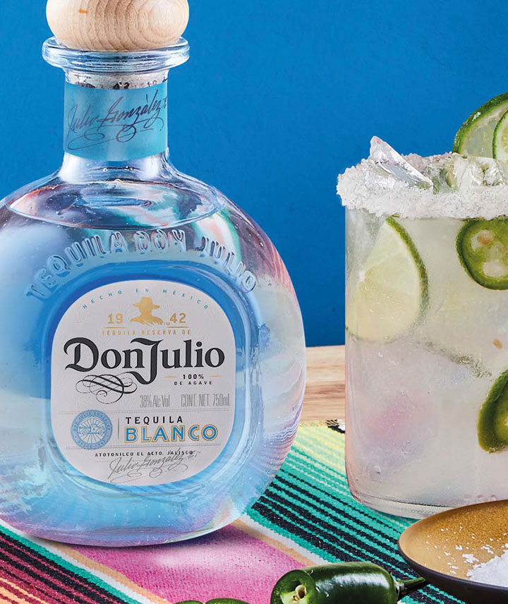 A bottle of Don Julio Tequila beside a Spicy Margarita 