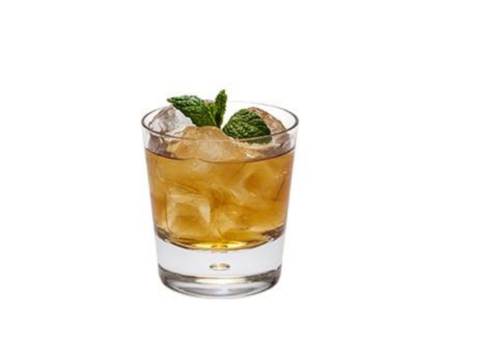 An Old Roe & Co cocktail with a mint leaf garnish.