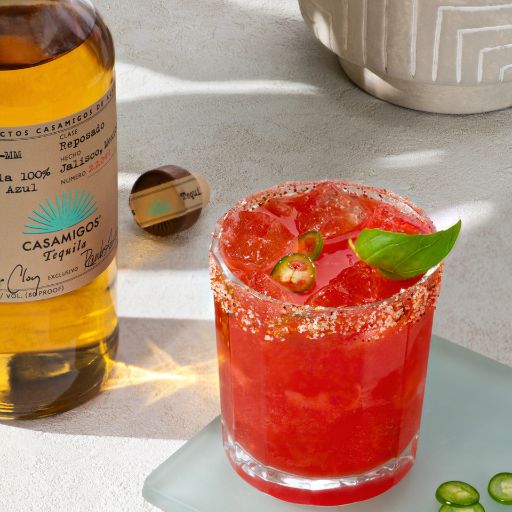 A spicy margarita with garnish and casamigos bottle