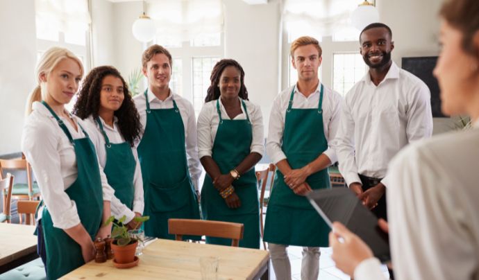Bar staff being addressed by a manager