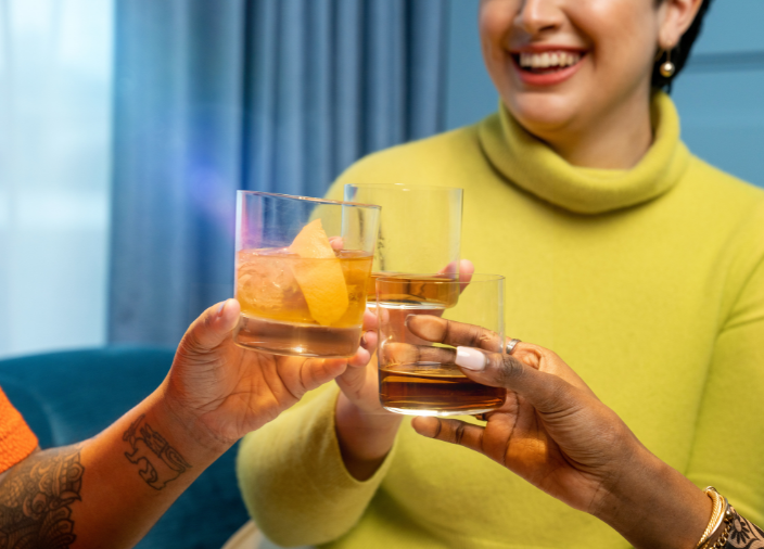 People clinking whisky glasses    