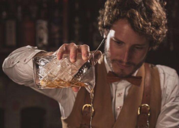 James Fowler pouring cocktail