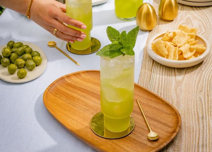 Cocktails with mint garnish on garden table