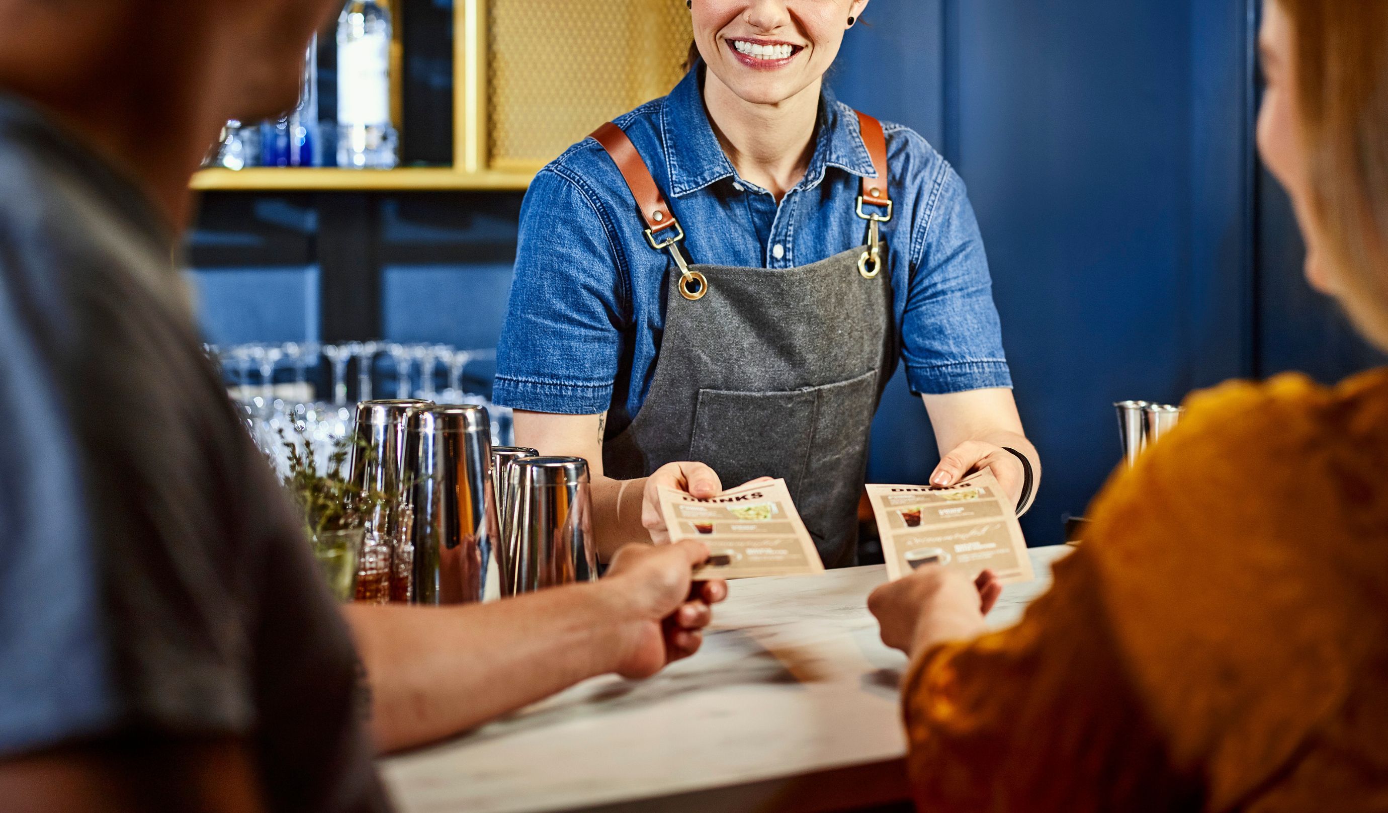 Bartender servindo água para dois convidados