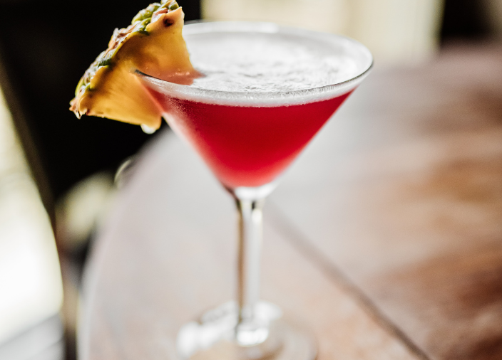   Cocktail in martini glass with pineapple slice    