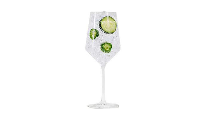 21Seeds Seed + Soda cocktail in a wine glass with lime wheel garnish
