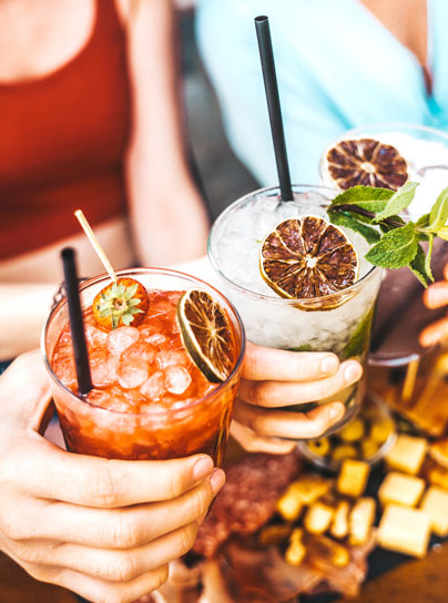 3 people holding cocktails 