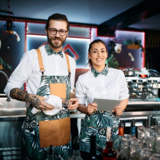 Bartenders preparing for their shift in an immaculate uniform 