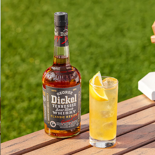 Bottle of Dickel on picnic table with cocktail