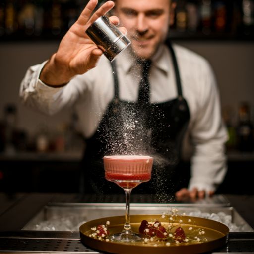  Bartender finishing up a high-end cocktail topping with garnish