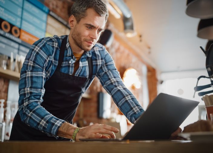 Bartender using a laptop computer