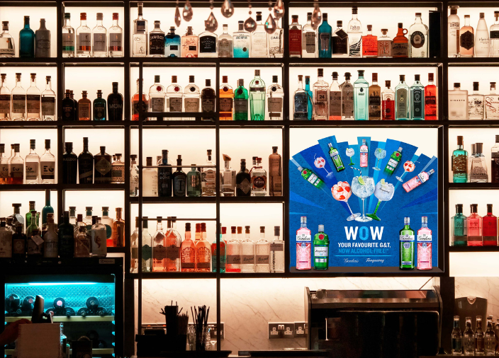 A backbar wall filled with bottles of alcoholic and non-alcoholic beverages.