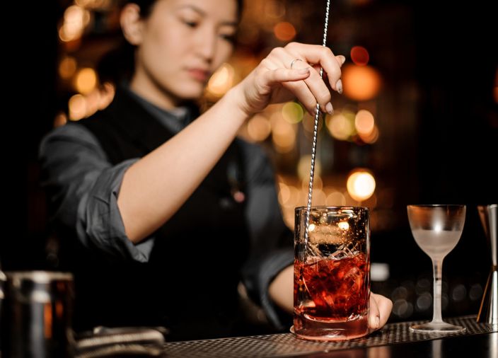 bartender stirring a made up cocktail