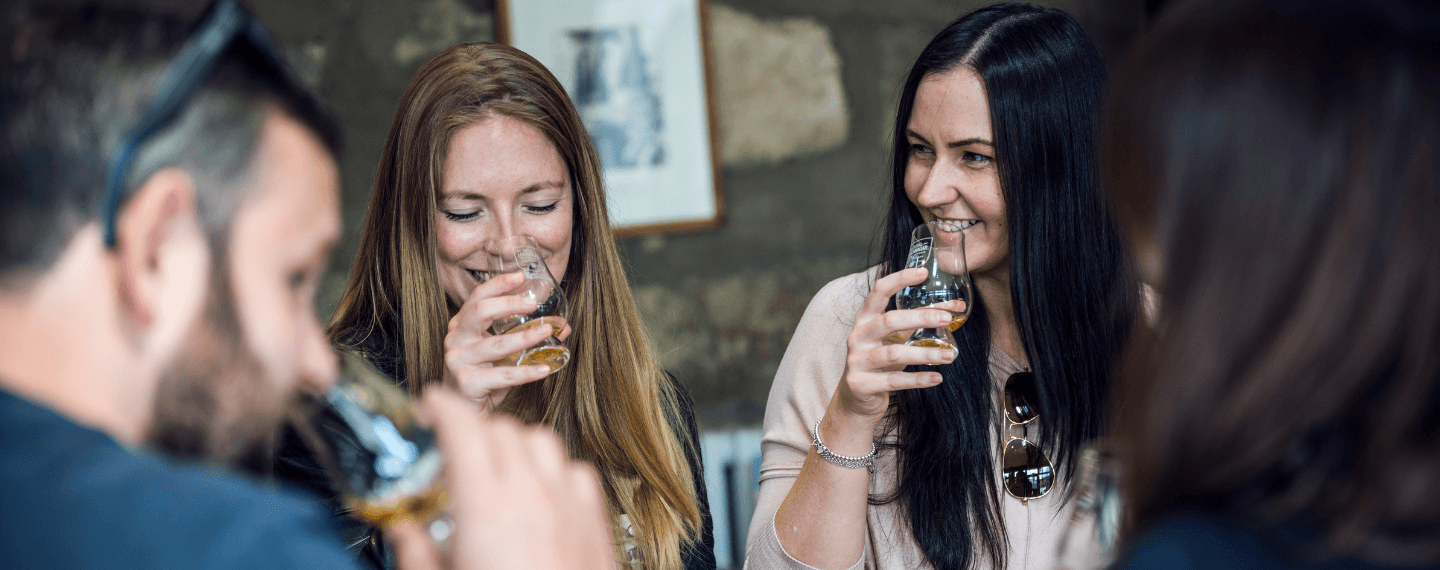 people smiling with cocktails