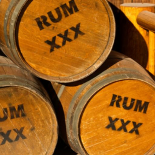 A group of stacked barrels with the word ‘RUM’ printed on them.