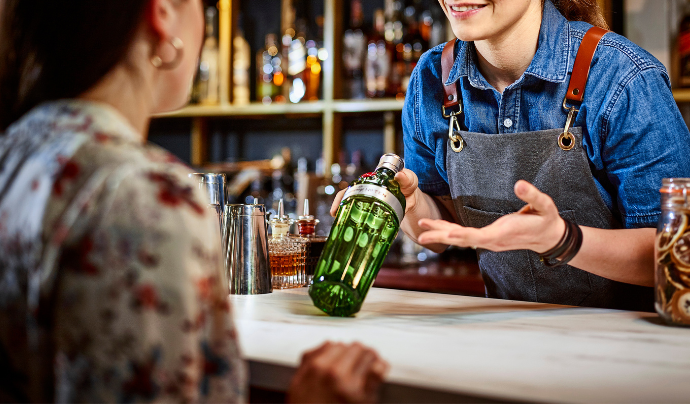 Bartender showing a product to a guest.