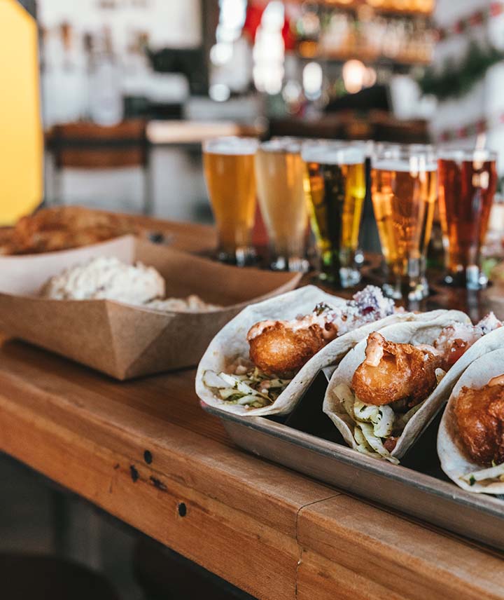A tasty selection of Tacos and beers on the bar top