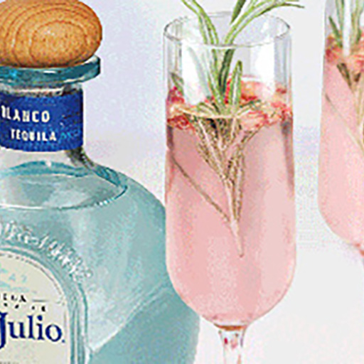 Bottle of Don Julio and two cocktails in tall flute glasses