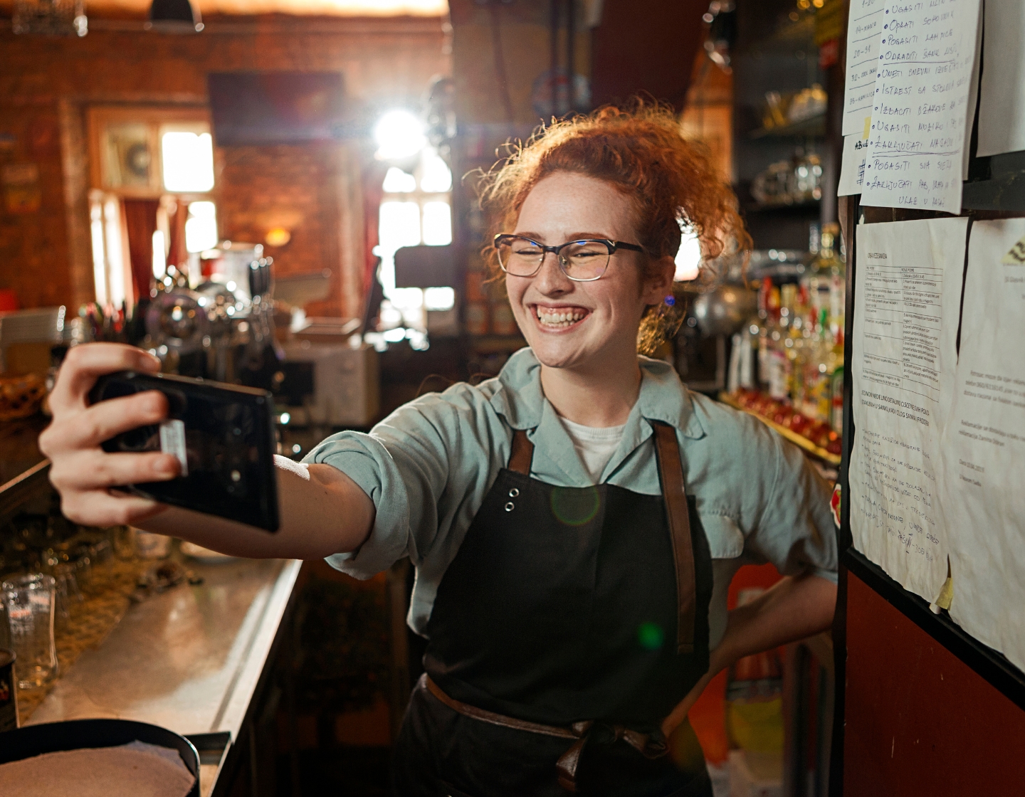 A bartender using a laptop