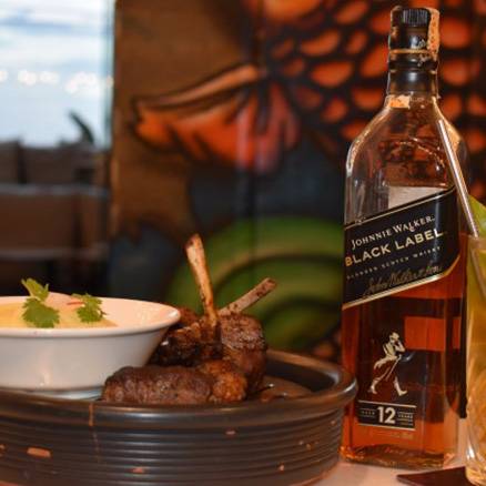 Bottle of Johnnie Walker Black Label and a cocktail