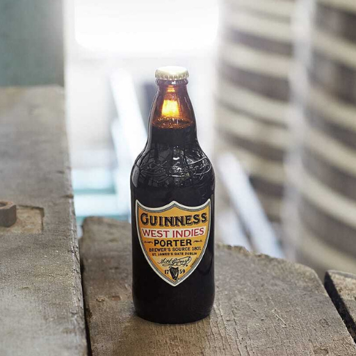 Bottle of Guinness West Indies Porter on wooden boards
