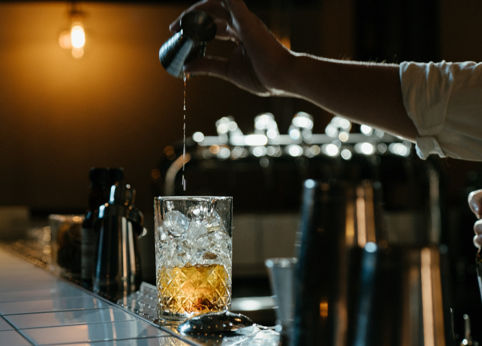 Bartender pouring drink with jigger 