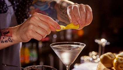 Bartender cutting an orange