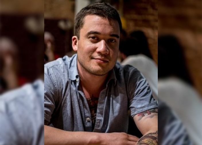 Headshot of male bartender Jess Vida in mood lighting.