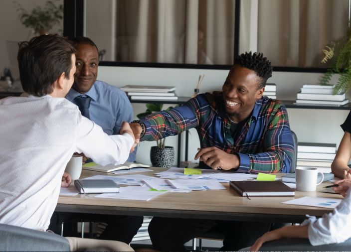 An image of a manager delivering a staff briefing to a group of staff to illustrate the principle of sharing your vision in the article