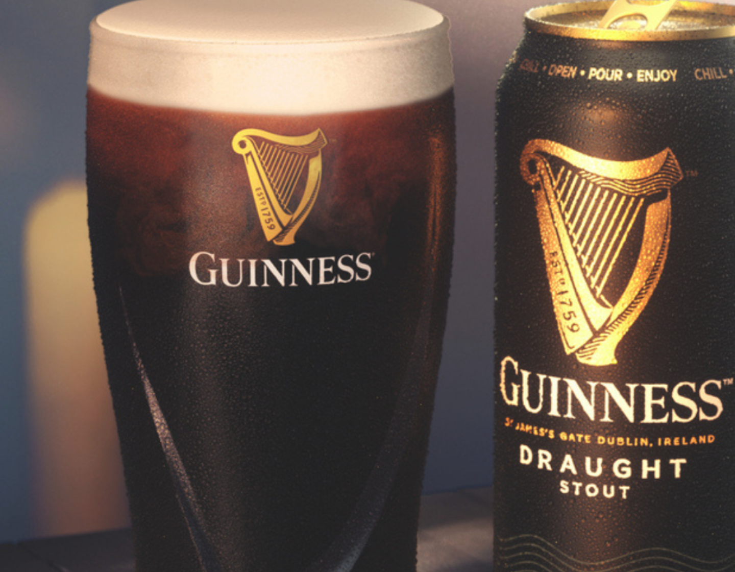 Pint of Guinness Draught in glass beside can of Guinness Draught Stout